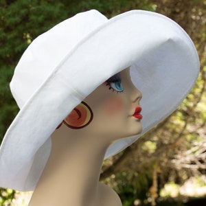 White cotton duck summer hat with very wide brim. White on both sides. Brim is easy to fashion. Looks glamourous.