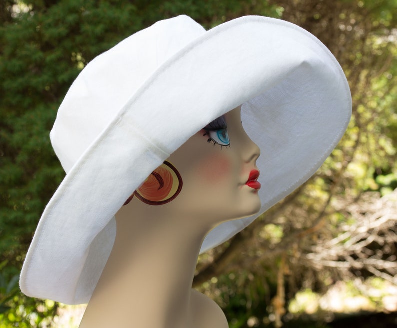 White cotton duck summer hat with very wide brim. White on both sides. Brim is easy to fashion. Looks glamourous.