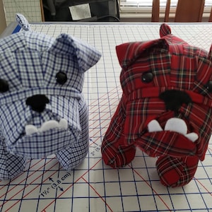 May include: Two handmade plush bulldog toys. One is blue and white plaid and the other is red and black plaid.