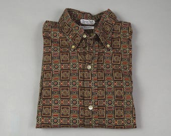 May include: A brown, long-sleeved button-down shirt with a geometric pattern in shades of red, gold, and green.