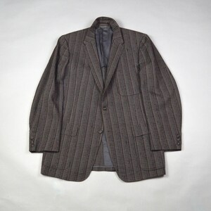 May include: A brown and gray striped blazer with a notched lapel, two front pockets, and buttoned cuffs. The jacket has a two-button closure and a gray interior lining. This classic blazer is suitable for various occasions.