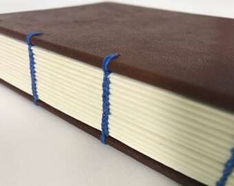 Handmade Coptic Journal: Exposed sewing and fabric hard covers.