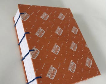 Handmade Coptic Journal: Exposed sewing and fabric hard covers.