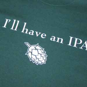 May include: A green t-shirt with white text that reads "I'll have an IPA" and a white graphic of a hop cone.