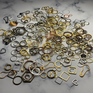 May include: A large assortment of silver, gold, and bronze metal jump rings, circles, and other shapes. These metal findings are perfect for jewelry making and crafting.