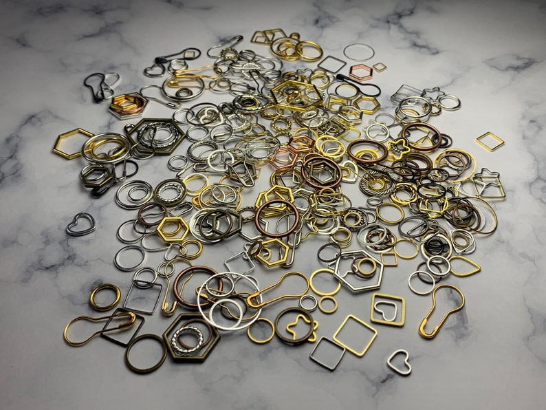 May include: A large assortment of silver, gold, and bronze metal jump rings, circles, and other shapes. These metal findings are perfect for jewelry making and crafting.