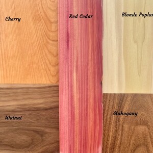 May include: Close-up of six wood samples, each labeled with its name: Cherry, Red Cedar, Blonde Poplar, Walnut, Mahogany. The wood samples are arranged in a grid pattern.