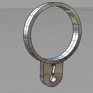 May include: A silver metal ring with a small, round, silver tag attached to the bottom. The tag has a small hole in the center and the number "7" printed on it.