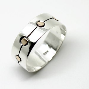Silver and 14K gold band wedding ring with a graphic look .Size 7.