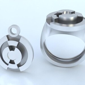 May include: A silver ring and pendant featuring a geometric design with a circular shape. The ring has a wide band and the pendant has a loop for attaching to a chain.
