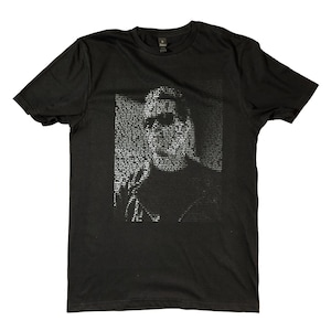 May include: Black t-shirt with a white graphic print of a person's face made of text.