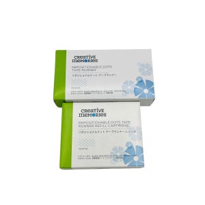 May include: Two white and green Creative Memories boxes. The top box reads "REPOSITIONABLE DOTS TAPE RUNNER" with Japanese text below. The bottom box reads "REPOSITIONABLE DOTS TAPE RUNNER REFILL CARTRIDGE". Both boxes have a floral design.