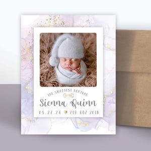 May include: Custom baby announcement magnets with a photo of a newborn baby. The magnet features the baby's name, birthdate, and contact information. A brown envelope with baby footprints is included. The text "custom magnets" is written in pink cursive.