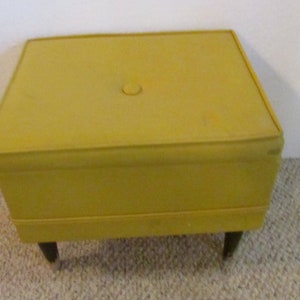 Footstool ,Ottoman Sewing chest , 4 wood legs and Yellow padded top, plastic sewing trays inside