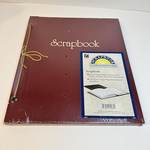 May include: A maroon scrapbook with a gold string tie closure. The cover features the word Scrapbook in gold lettering. A rectangular label on the front includes the text Scrapbook Postbound/String Tied, 100 Heavy Gauge Pages, and a barcode.