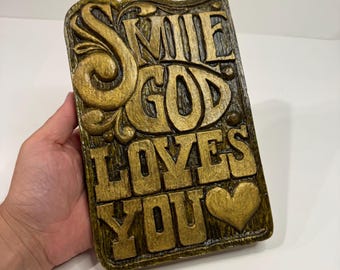 Vintage 1970s "Smile God Loves You" chalkware wall plaque. Wall hanging sign