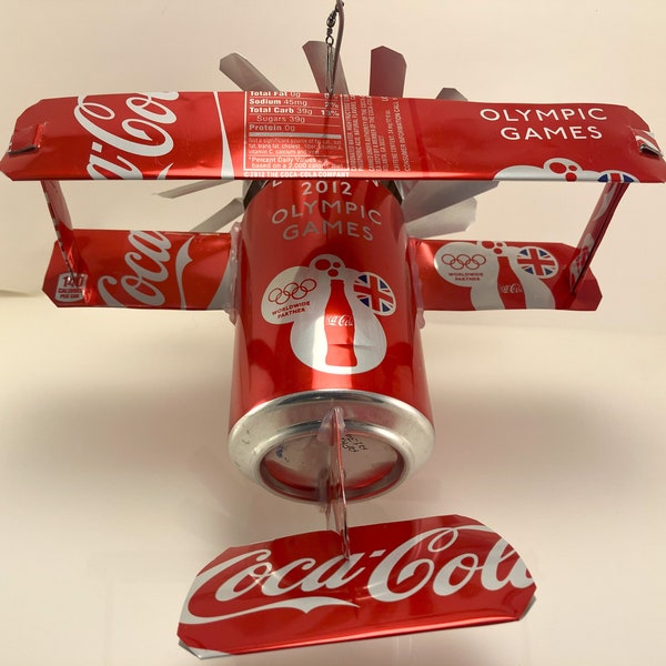 Airplane whirl-a-gig Made From Coca Cola London Olympic Game Cans