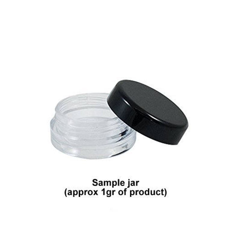 May include: A clear plastic jar with a black lid. The jar is labelled "Sample jar (approx 1gr of product)".