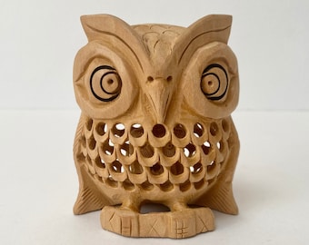 Vintage hand-carved small wooden owl ornament with baby owl inside, intricate lattice design, symbolic