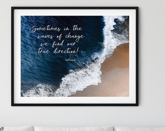 May include: A framed print with a quote about finding your true direction in the waves of change. The print features an aerial view of a sandy beach with blue ocean waves crashing on the shore.