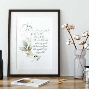 May include: A framed print with a watercolor illustration of leaves and gold accents. The print features a quote that reads "Today, I choose to live with gratitude for the love that fills my heart, the peace that rests within my spirit, and the source of hope that says all things are possible!"