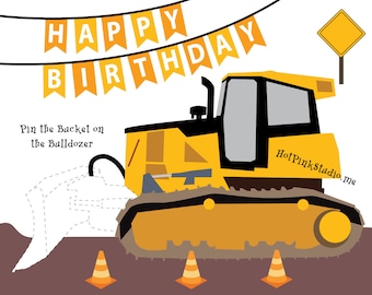 May include: A yellow bulldozer with a black bucket and tracks. The bulldozer is on a brown surface with three orange cones. The text "Pin the Bucket on the Bulldozer" is above the bulldozer. A banner with the text "Happy Birthday" is at the top of the image.