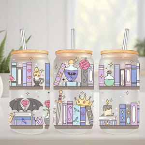 May include: Three glass tumblers with bamboo lids and silver straws. Each tumbler features a whimsical design of bookshelves, candles, potions, and fantasy elements in pastel colors. A decorative and functional item.