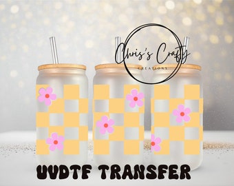 May include: Three clear tumblers with a yellow and white checkered pattern and pink flowers. The tumblers have bamboo lids and clear straws. The text "UV DTF TRANSFER" is at the bottom of the image.