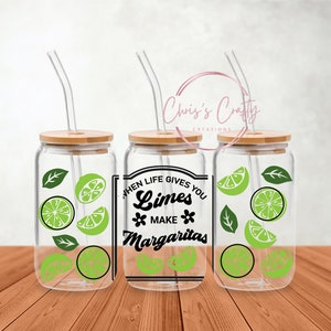 May include: Three clear glass mason jars with bamboo lids and reusable straws. Each jar has a lime and leaf design and the text "When life gives you limes make margaritas".