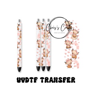 May include: Three white pens with a pink and brown Highland cow pattern. The pens are on a white background with the text "Chris's Crafty Creations" and "UV/DT/F TRANSFER" in black.