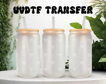 May include: Three frosted glass tumblers with white heart patterns and bamboo lids. Each tumbler has a clear plastic straw.