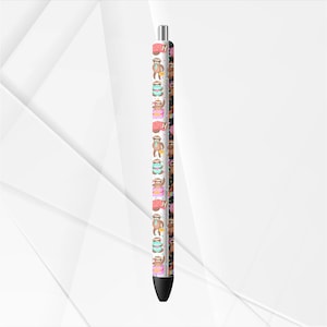 May include: A black pen with a repeating pattern of cartoon sloths wearing hats and holding various items. The sloths are in different colors, including pink, blue, and brown. The pen has a silver tip and a black tip.