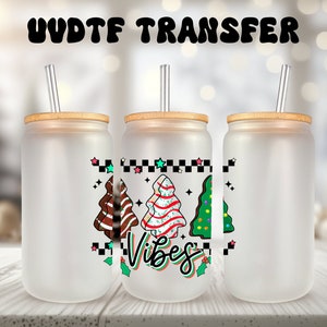 May include: Three frosted glass tumblers with bamboo lids and clear straws. Each tumbler features a different Christmas tree design with the text "Vibes" in a retro font.