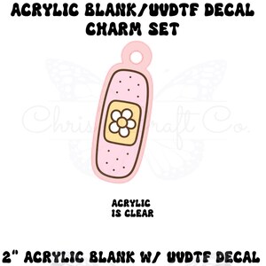 May include: A pink acrylic charm in the shape of a bandage, with a yellow flower design. The charm has a hole at the top for hanging. Text on the image reads "ACRYLIC BLANK/UUDTF DECAL CHARM SET" and "ACRYLIC IS CLEAR". The charm is 2 inches.