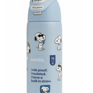 May include: A light blue Owala water bottle featuring Snoopy illustrations. The bottle has a push-button lid and includes the text "Leak proof. Insulated. I have a built-in straw." It is designed to keep liquids cold for 24 hours.