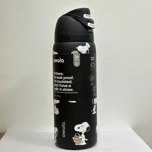 May include: Black Owala water bottle featuring Snoopy illustrations. The bottle has a black lid with a push button and a built-in straw. The bottle is insulated and leak-proof. The bottle is 745 ml.