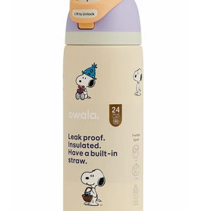 May include: A cream-colored Owala water bottle featuring Snoopy illustrations. The bottle has a push-button lid with a lavender and yellow top. Text on the bottle reads "Leak proof. Insulated. Have a built-in straw."