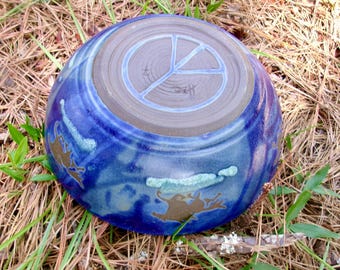 The wild horses of the Outer Banks frolic in the dramatic blue glazes of this large serving bowl