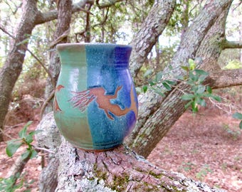 A mermaid and 3 peace turtles swim and play across this  coffee mug