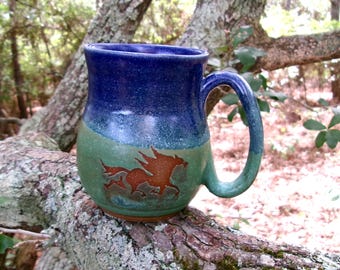 The wild horses of Corolla  gallop around the outside of this sweet  obx coffee mug