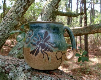 Bees and pieces of honeycomb decorate this sweet and unique large mug