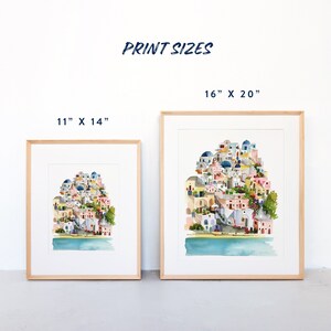 Peut inclure: Deux impressions encadr&eacute;es d'une peinture &agrave; l'aquarelle repr&eacute;sentant une ville color&eacute;e avec des b&acirc;timents blancs, des d&ocirc;mes bleus et des arbres verts. Les tailles d'impression sont de 11" x 14" et 16" x 20".