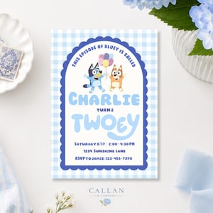 May include: A rectangular party invitation card with a light blue gingham border. The centre features Bluey and Bingo characters holding balloons, with text reading: This episode of Bluey is called Charlie turns twoey, Saturday 8/17 2:00-4:30 PM, 1234 Sunshine Lane, RSVP to Jamie: 123-456-7890.