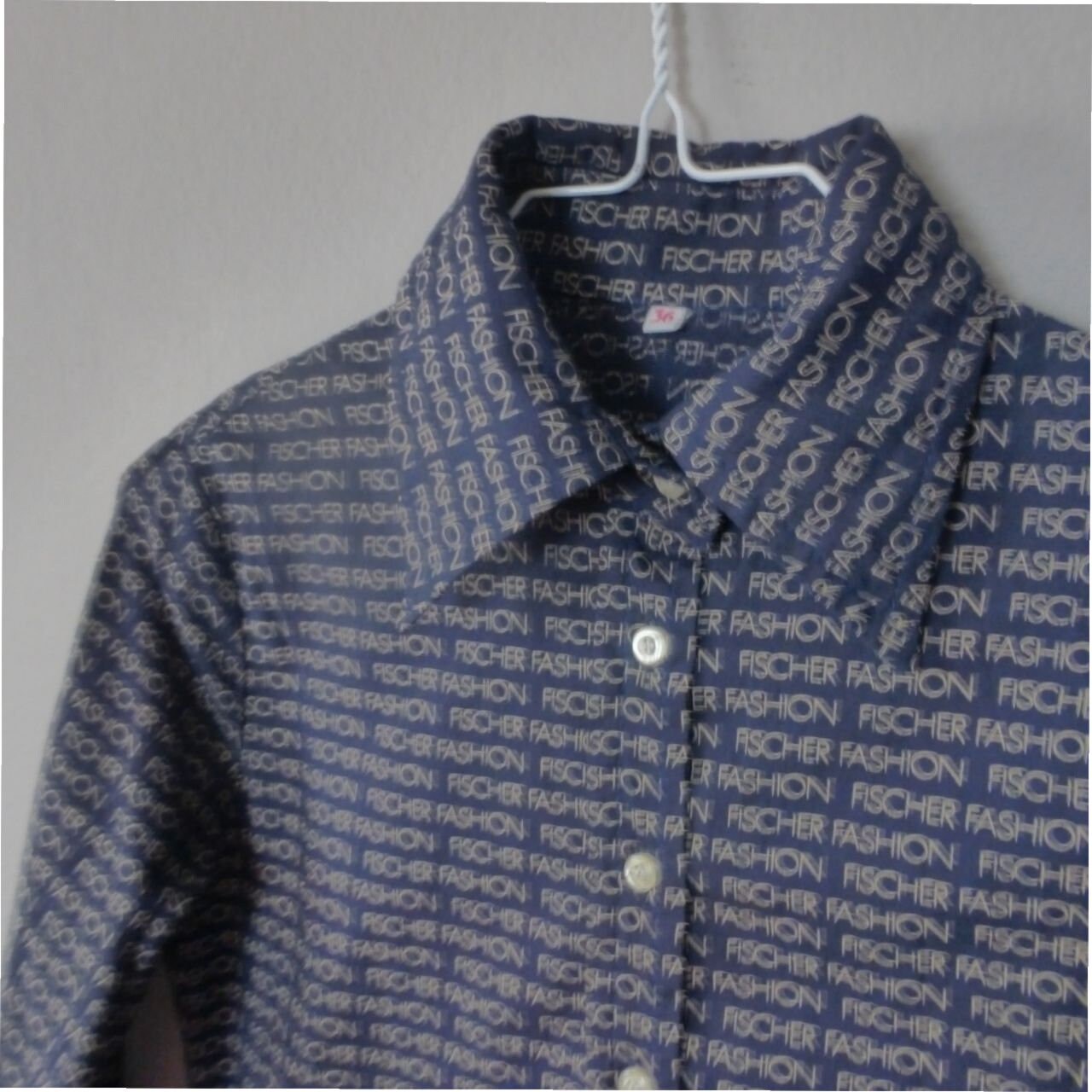 70s Fischer Fashion shirt. XS size. Dark blue women's slim fit hippie top with beige repeated logo print. In excellent vintage condition.