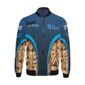 May include: A blue bomber jacket with a black collar and cuffs. The jacket features the Amazon Prime logo and the name "Mike" on the front. The design includes a pattern of Amazon boxes.