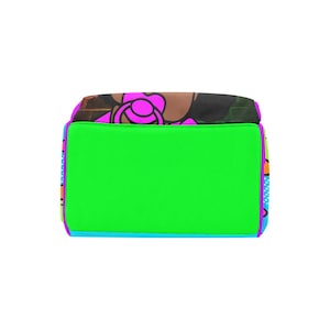 May include: A rectangular tote bag with a bright green center panel, framed by a purple border. The sides feature a colorful pattern with blue, orange, and purple accents. The top has a floral design with pink and brown hues.