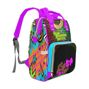 May include: A vibrant backpack with a graffiti-style design. The bag features a colorful pattern with pink, green, and orange accents. The side pocket displays a cartoon girl with a pink bow. The text "Fresh Princess Bella" is visible.