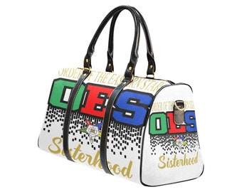 May include: White duffel bag with black handles and straps. The bag features the letters "OES" in green, red, and blue, with the words "Order of the Eastern Star" and "Sisterhood" in gold. A small emblem is also visible.