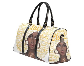 May include: A white travel bag featuring a portrait of a Black woman with gold hoop earrings and a gold necklace. The bag has black handles and the word "BLACK" in large gold letters. The bag is decorated with words like "Strong", "Proud", and "Melanin".