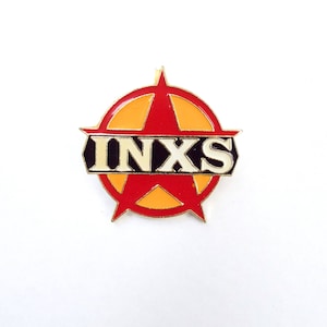 May include: A red and yellow star with the word "INXS" in black letters inside. The star is surrounded by a circle.